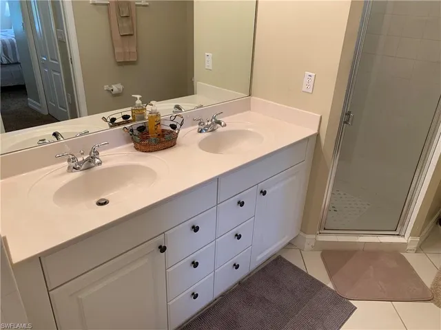 a bathroom with a double vanity sink and mirror