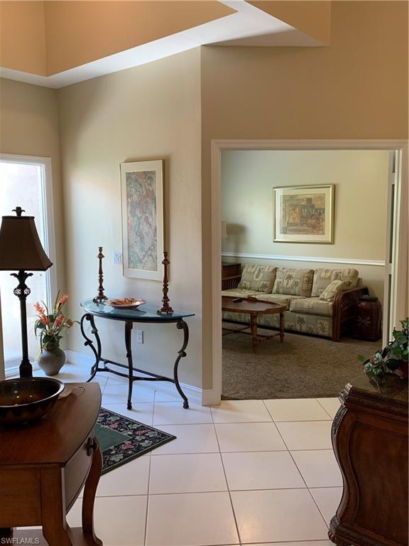 8133 Chancel Court, Unit 641 Naples, FL 34104 - Photo 16 of 25 a living room with furniture and a flat screen tv