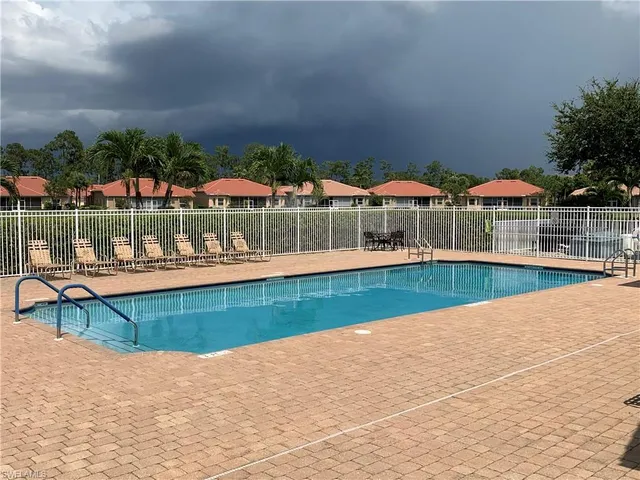 a view of swimming pool with outdoor seating and yard