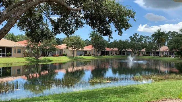 a view of residential house with outdoor space and lake