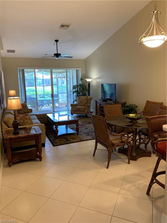8133 Chancel Court, Unit 641 Naples, FL 34104 - Photo 8 of 25 a living room with furniture and a chandelier
