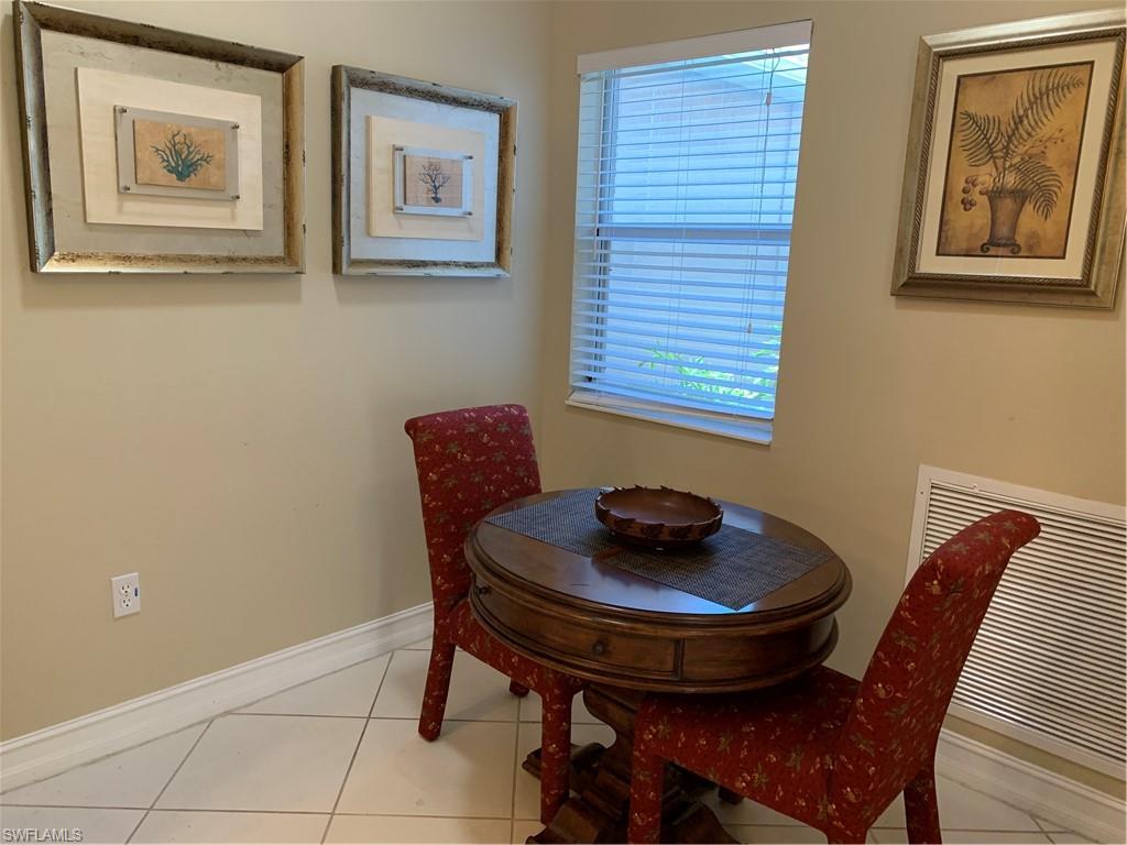 8133 Chancel Court, Unit 641 Naples, FL 34104 - Photo 10 of 25 a dining room with furniture and window