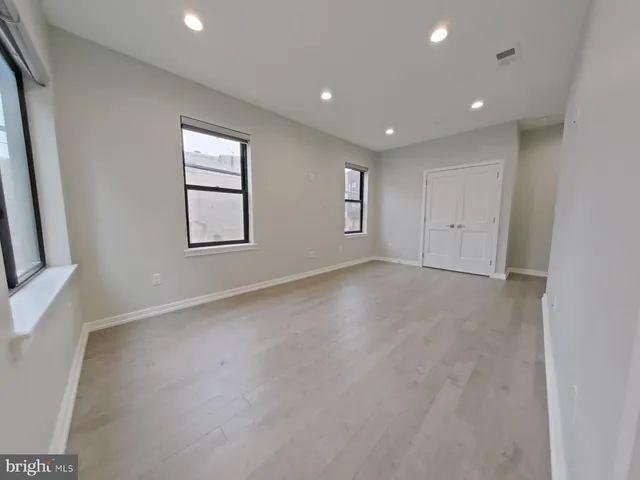 a view of a kitchen with wooden floor and a sink