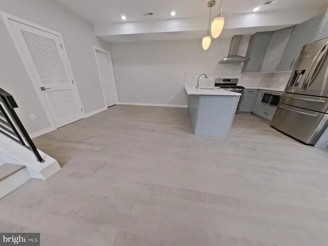 a kitchen with stainless steel appliances a refrigerator sink and microwave