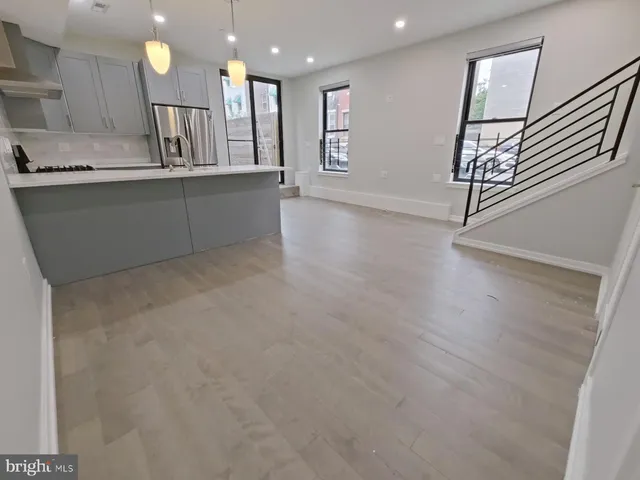 a living room with furniture and kitchen view