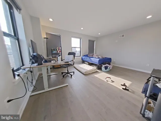 a living room with furniture a rug and white walls