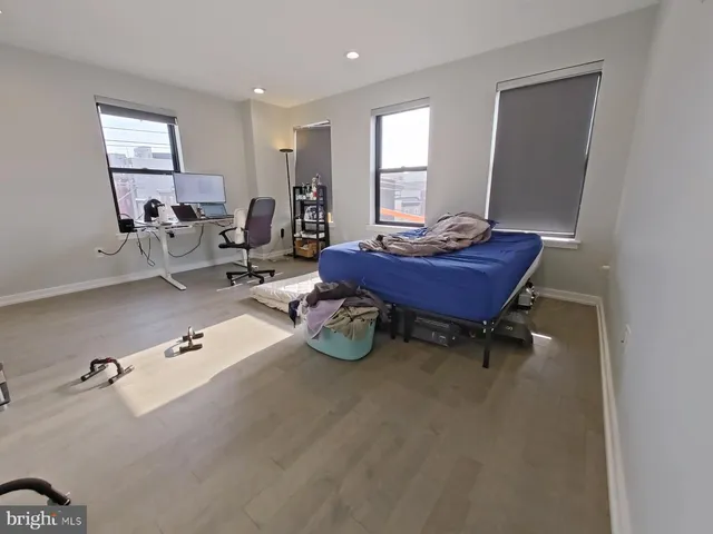 a bathroom with a toilet a sink a mirror and vanity