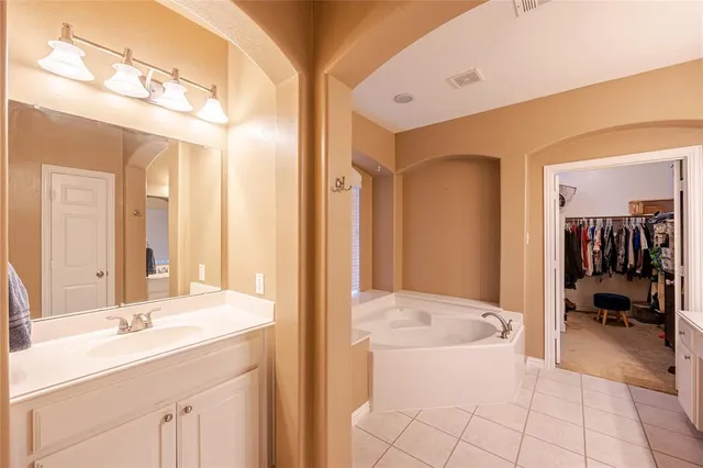 a en suite bathroom with a sink double vanity and a mirror