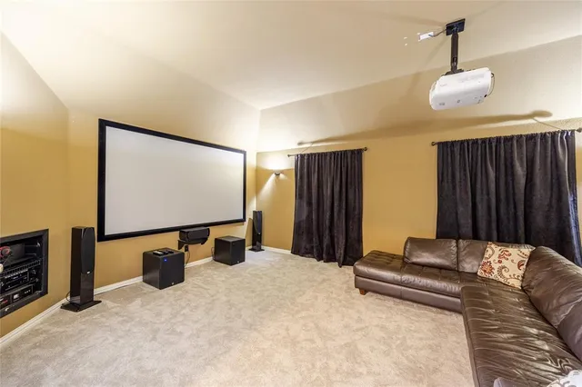 a projector room with a bed and a flat screen tv