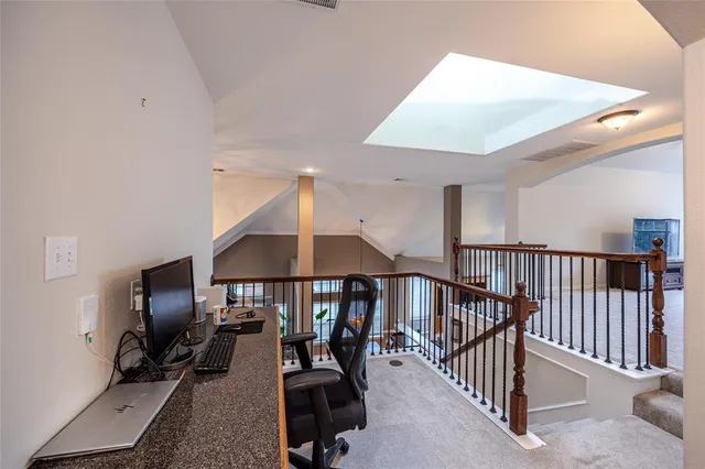 a view of a livingroom with furniture and staircase