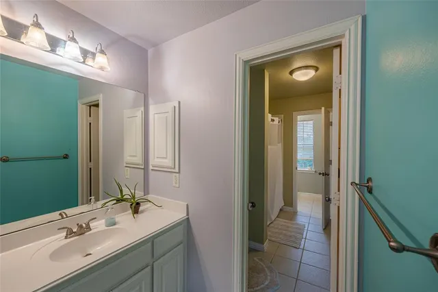 a bathroom with a double vanity sink and a mirror