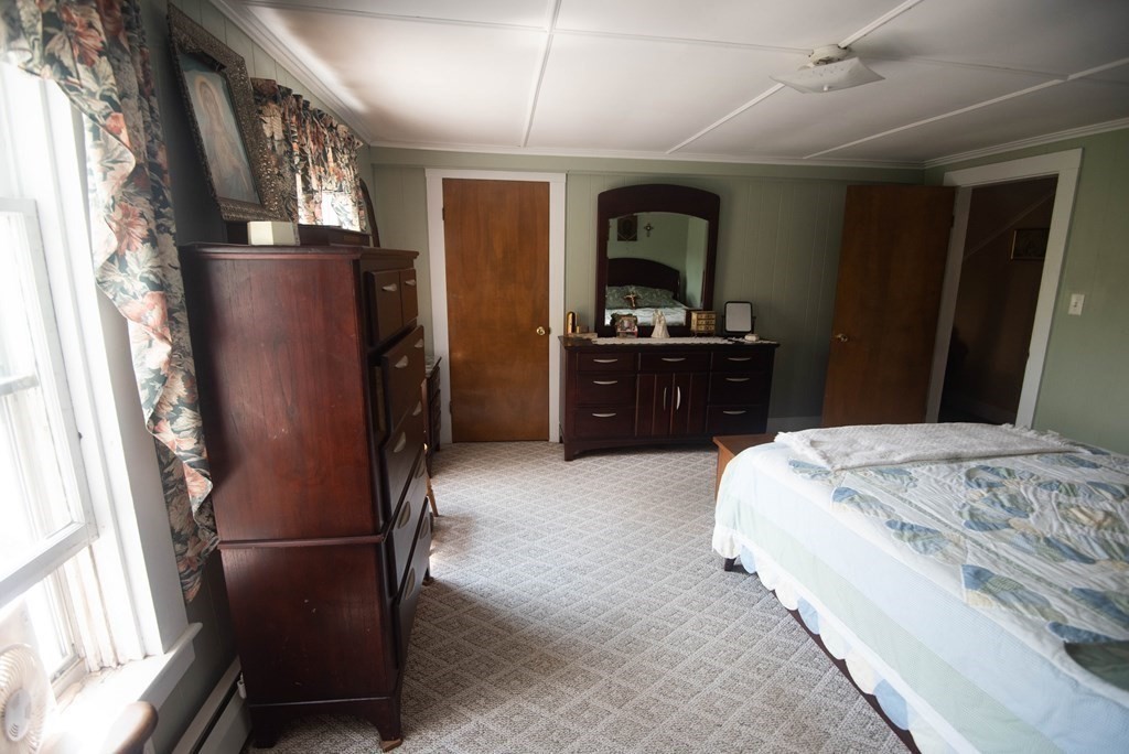 120 Adams Street Barre, MA 01005 - Photo 23 of 42 a bedroom with a large bed and a dresser