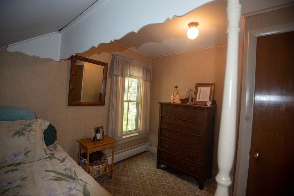 120 Adams Street Barre, MA 01005 - Photo 27 of 42 a bedroom with a bed and a dresser next to a window