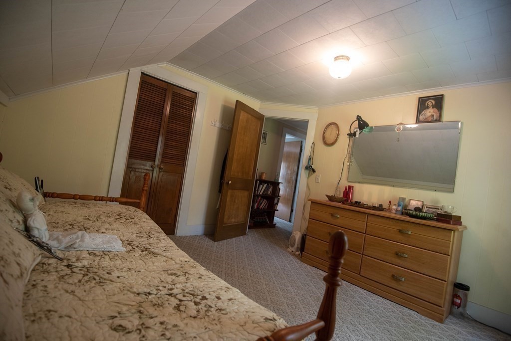 120 Adams Street Barre, MA 01005 - Photo 30 of 42 a bedroom with a bed and flat screen tv