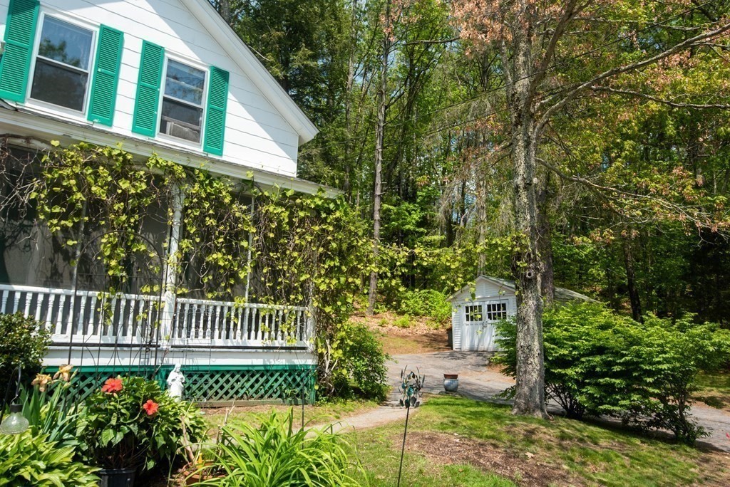 120 Adams Street Barre, MA 01005 - Photo 4 of 42 a view of a house with a small yard and wooden fence