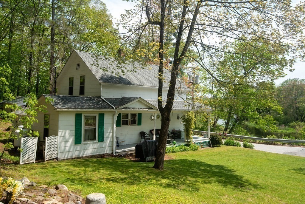 120 Adams Street Barre, MA 01005 - Photo 6 of 42 a front view of a house with a garden and trees