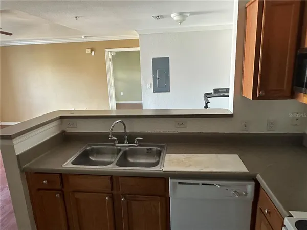 a kitchen with stainless steel appliances a sink stove and cabinets