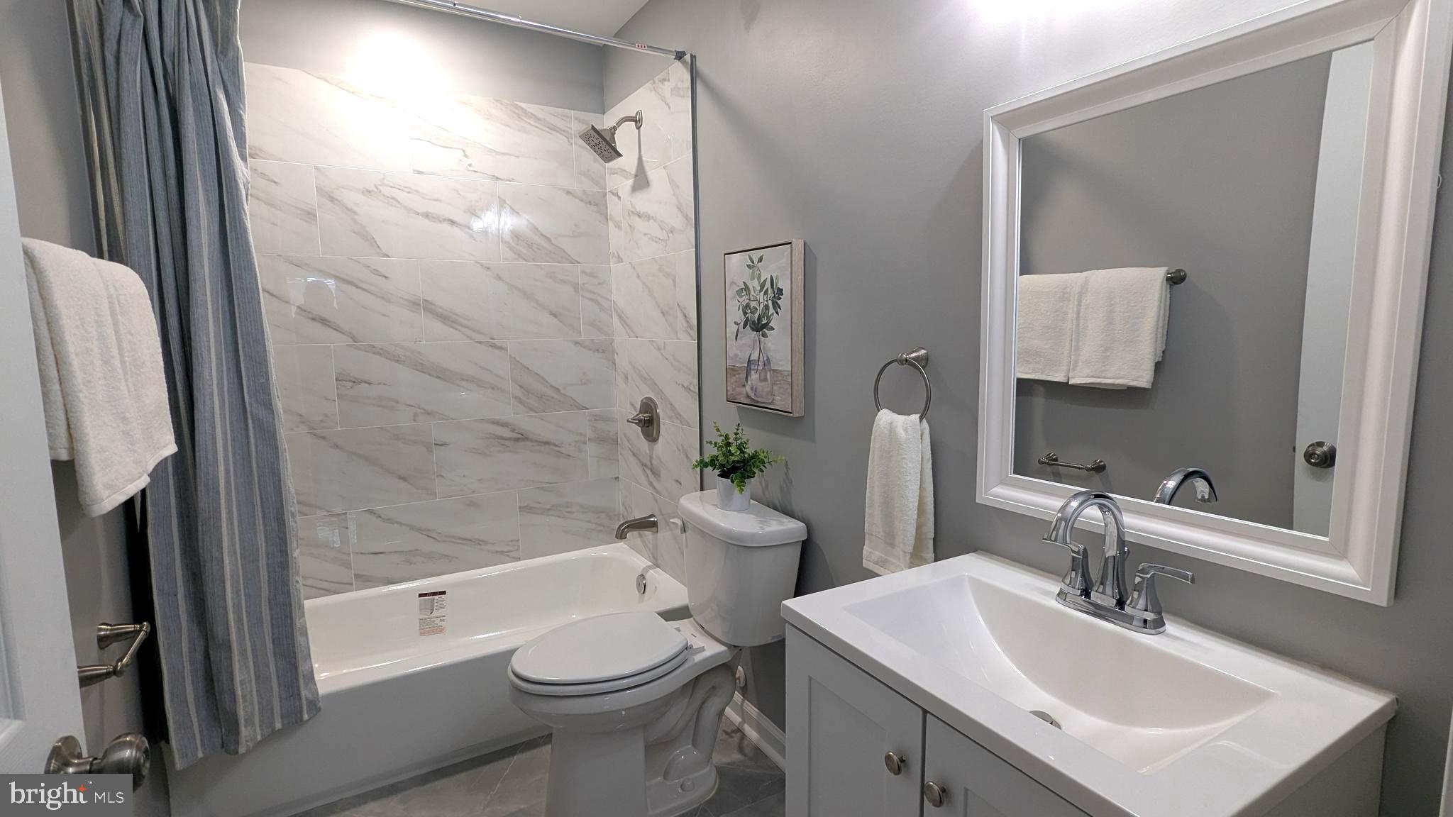 6211 Johnnycake Road Gwynn Oak, MD 21207 - Photo 12 of 26 a bathroom with a sink toilet and shower