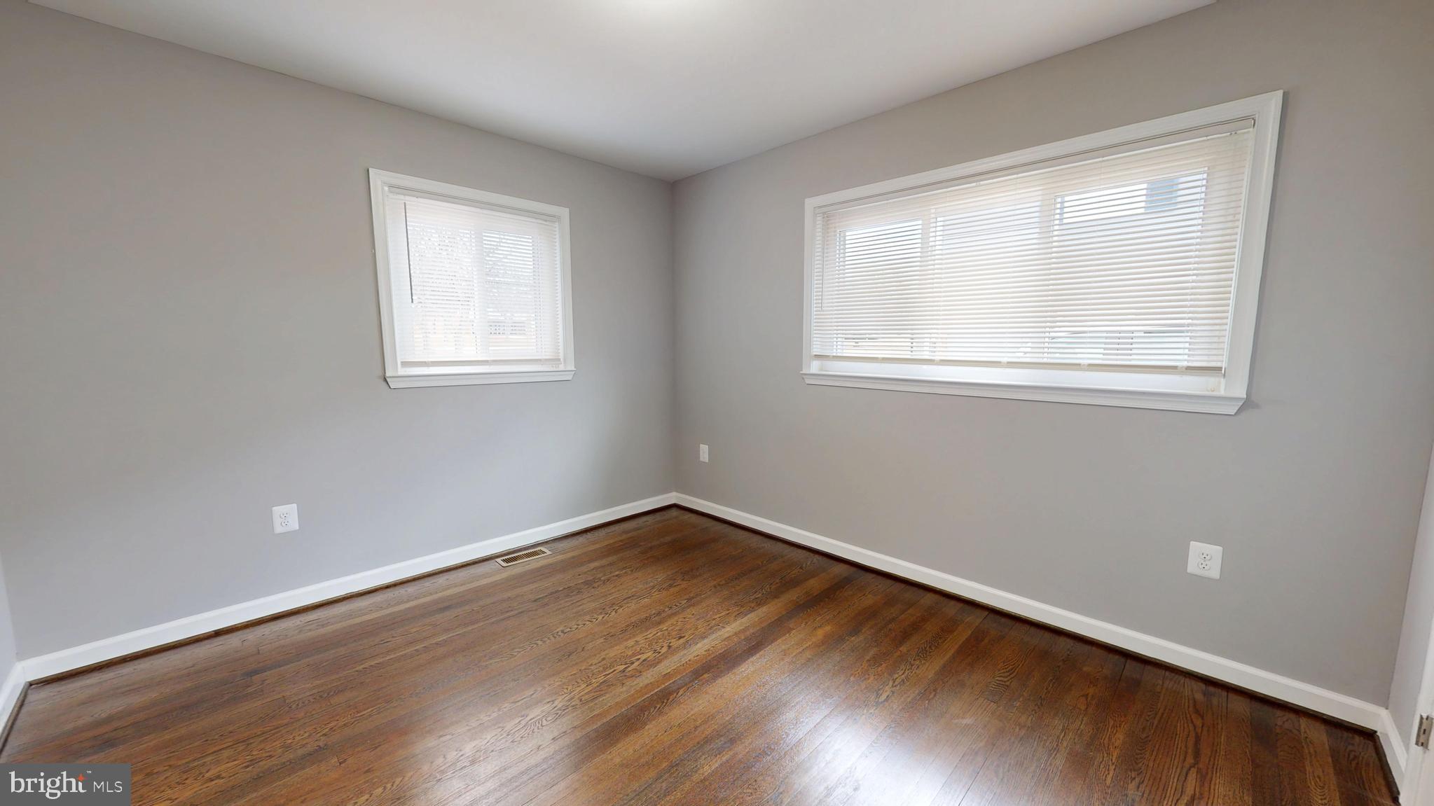 6211 Johnnycake Road Gwynn Oak, MD 21207 - Photo 13 of 26 an empty room with wooden floor and windows
