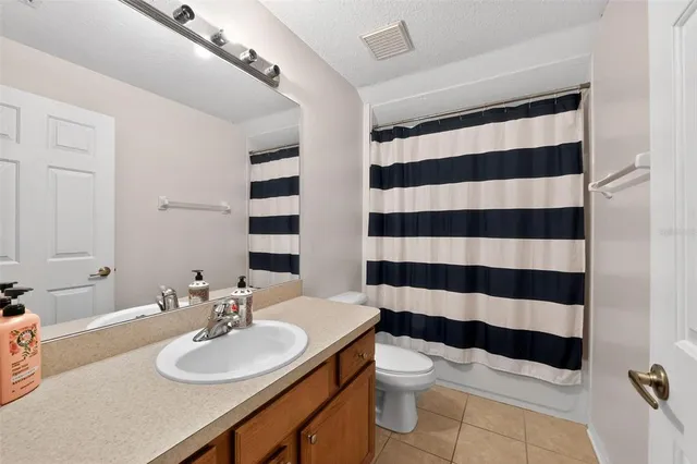 a bathroom with a tub sink and a mirror