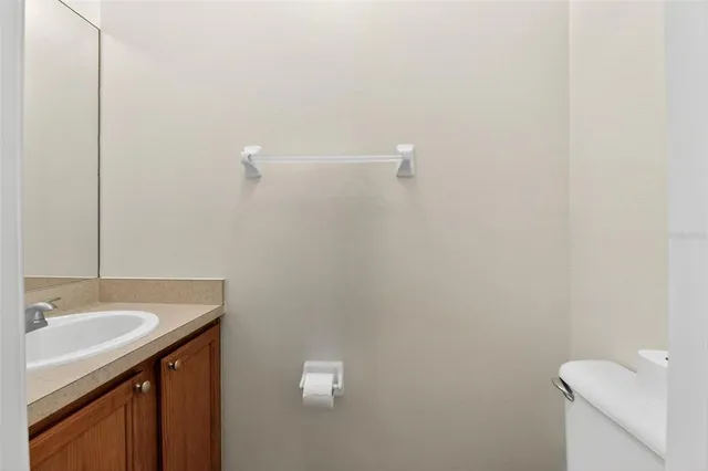 a view of an empty room with closet and a window