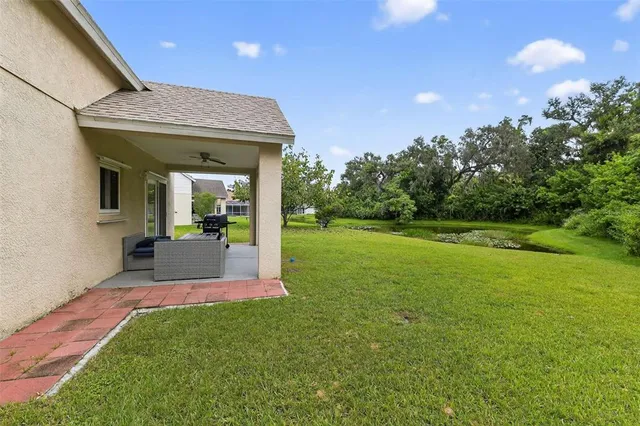 a view of a house with a porch and garden