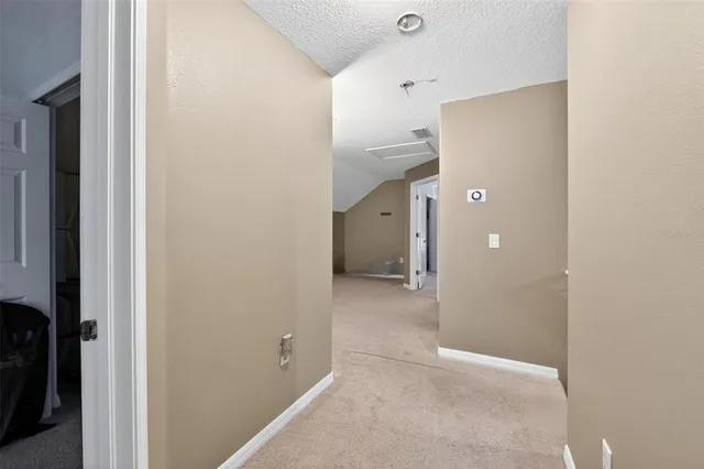 an empty room with a window and a ceiling fan