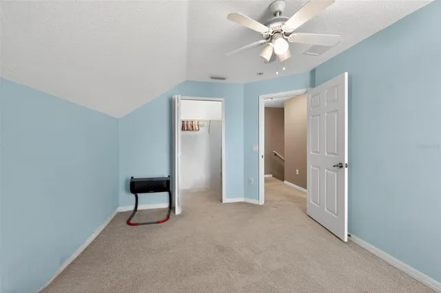 a view of walk in closet with clothes
