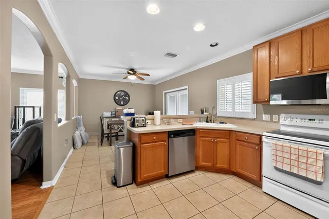 a large kitchen with kitchen island granite countertop lots of counter top space and stainless steel appliances
