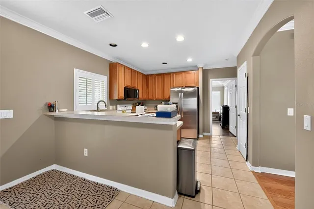 a kitchen with stainless steel appliances granite countertop a refrigerator and a sink