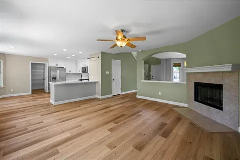 a view of a kitchen with a sink a kitchen counter top and a fireplace