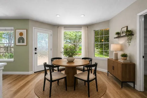 a dining room with furniture and window