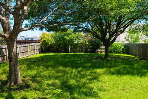 a backyard of a house with lots of green space