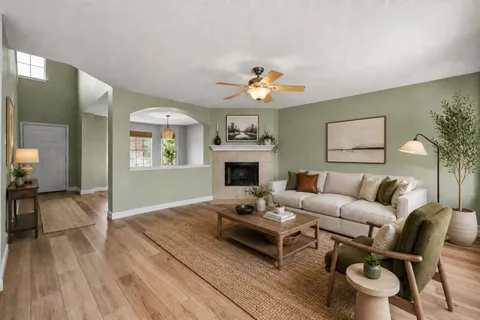 a living room with furniture a fireplace and a table