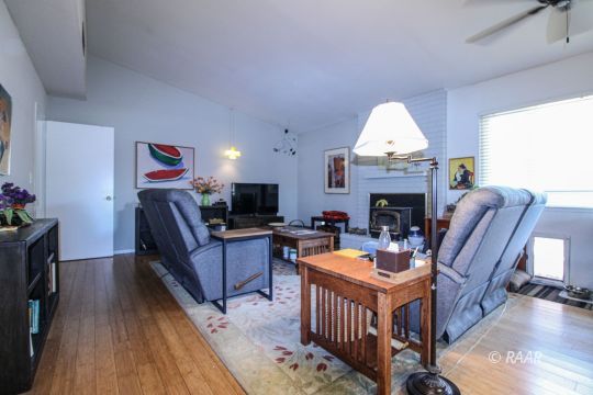 637 Randall Street Ridgecrest, CA 93555 - Photo 12 of 32 a living room with furniture a fireplace and a flat screen tv