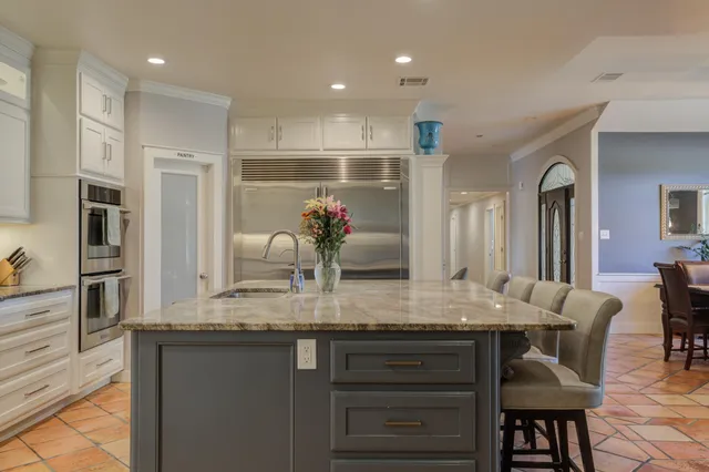 a bedroom with furniture and a large window