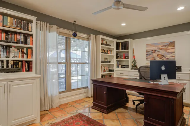 a kitchen with stainless steel appliances granite countertop a refrigerator a sink dishwasher a stove and white countertops with wooden floor