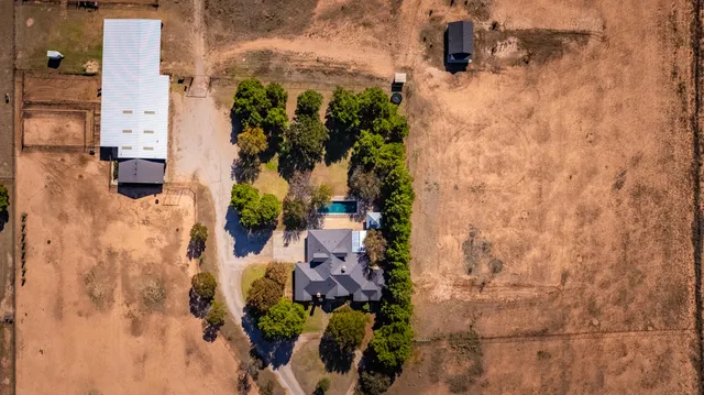 a kitchen with stainless steel appliances granite countertop a kitchen island a stove a table and chairs