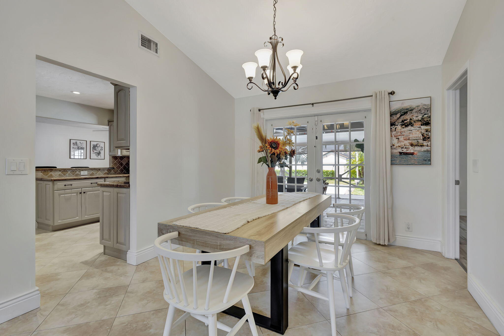 1104 Jackpine Street Wellington, FL 33414 - Photo 15 of 67 a view of a dining room with furniture and chandelier