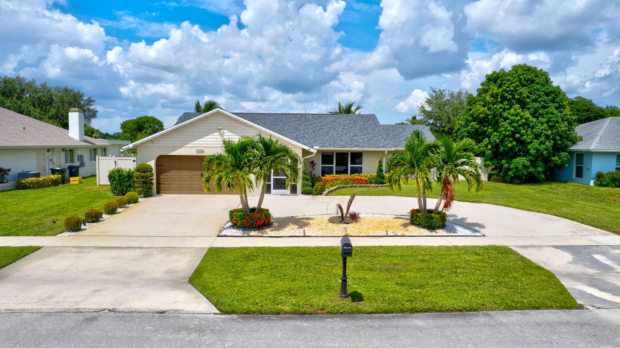 1104 Jackpine Street Wellington, FL 33414 - Photo 2 of 67 a front view of a house with garden
