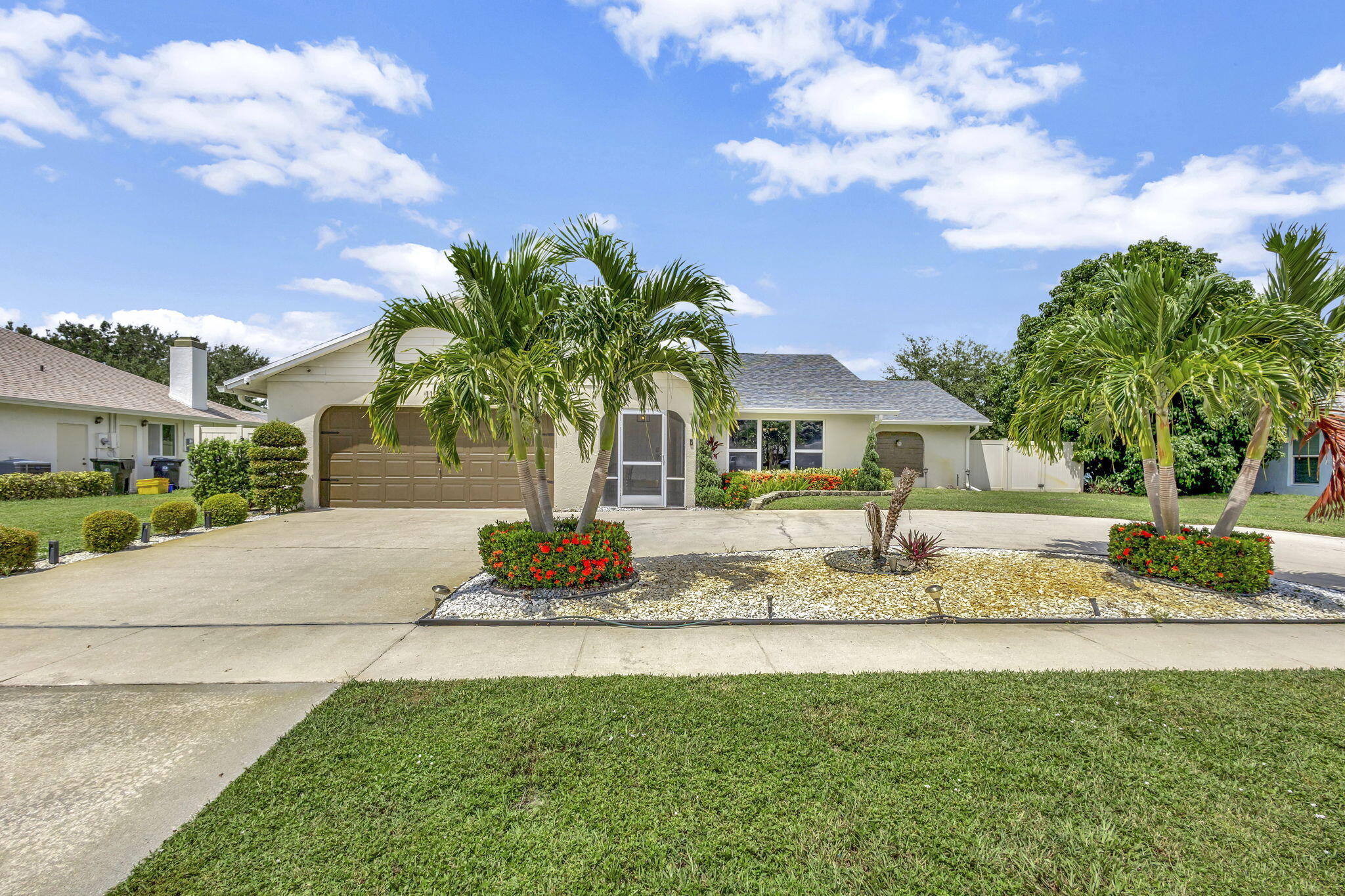1104 Jackpine Street Wellington, FL 33414 - Photo 32 of 67 a front view of a house with garden