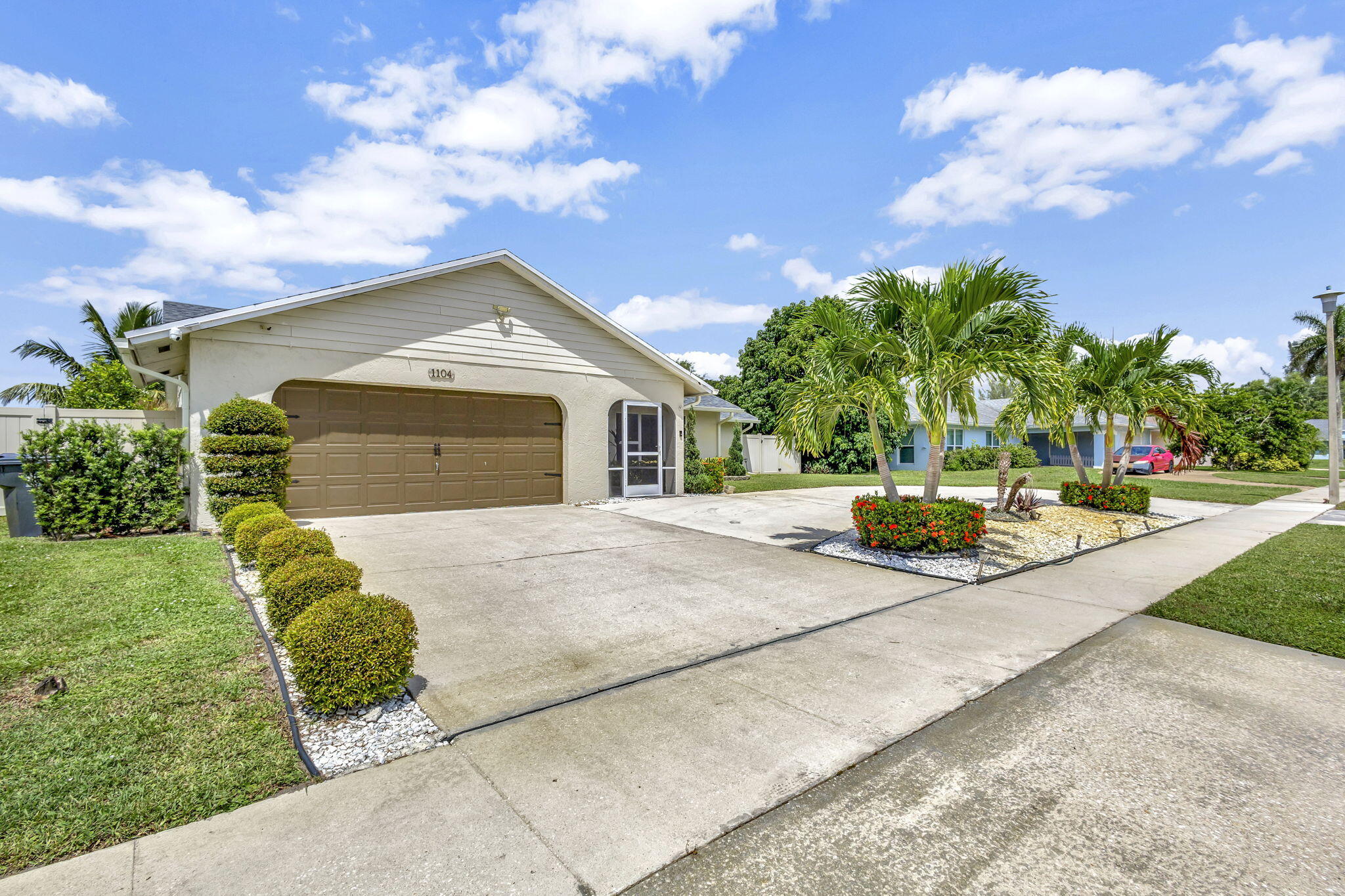 1104 Jackpine Street Wellington, FL 33414 - Photo 33 of 67 a front view of a house with a yard and garage