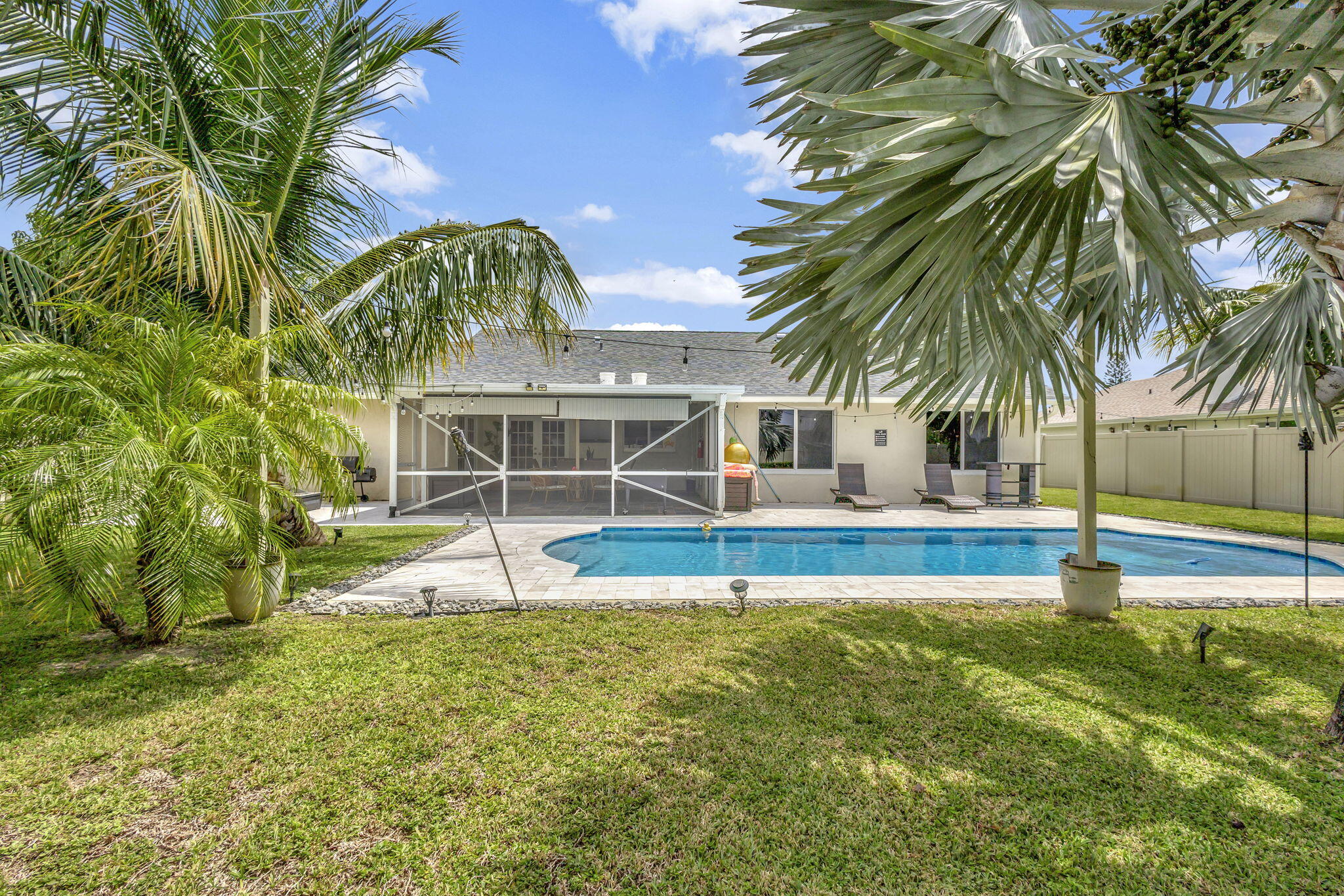 1104 Jackpine Street Wellington, FL 33414 - Photo 38 of 67 a view of a house with swimming pool and sitting area