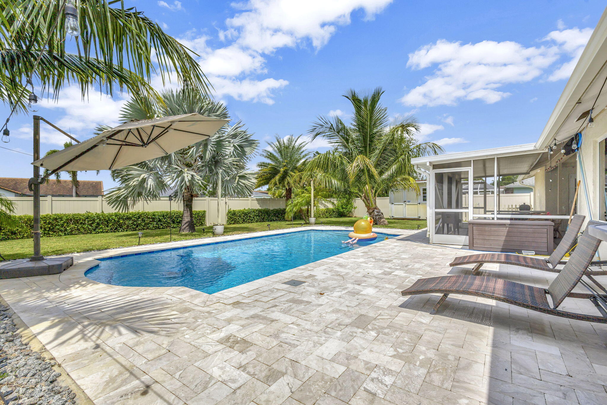 1104 Jackpine Street Wellington, FL 33414 - Photo 40 of 67 a view of swimming pool with a yard and sitting area