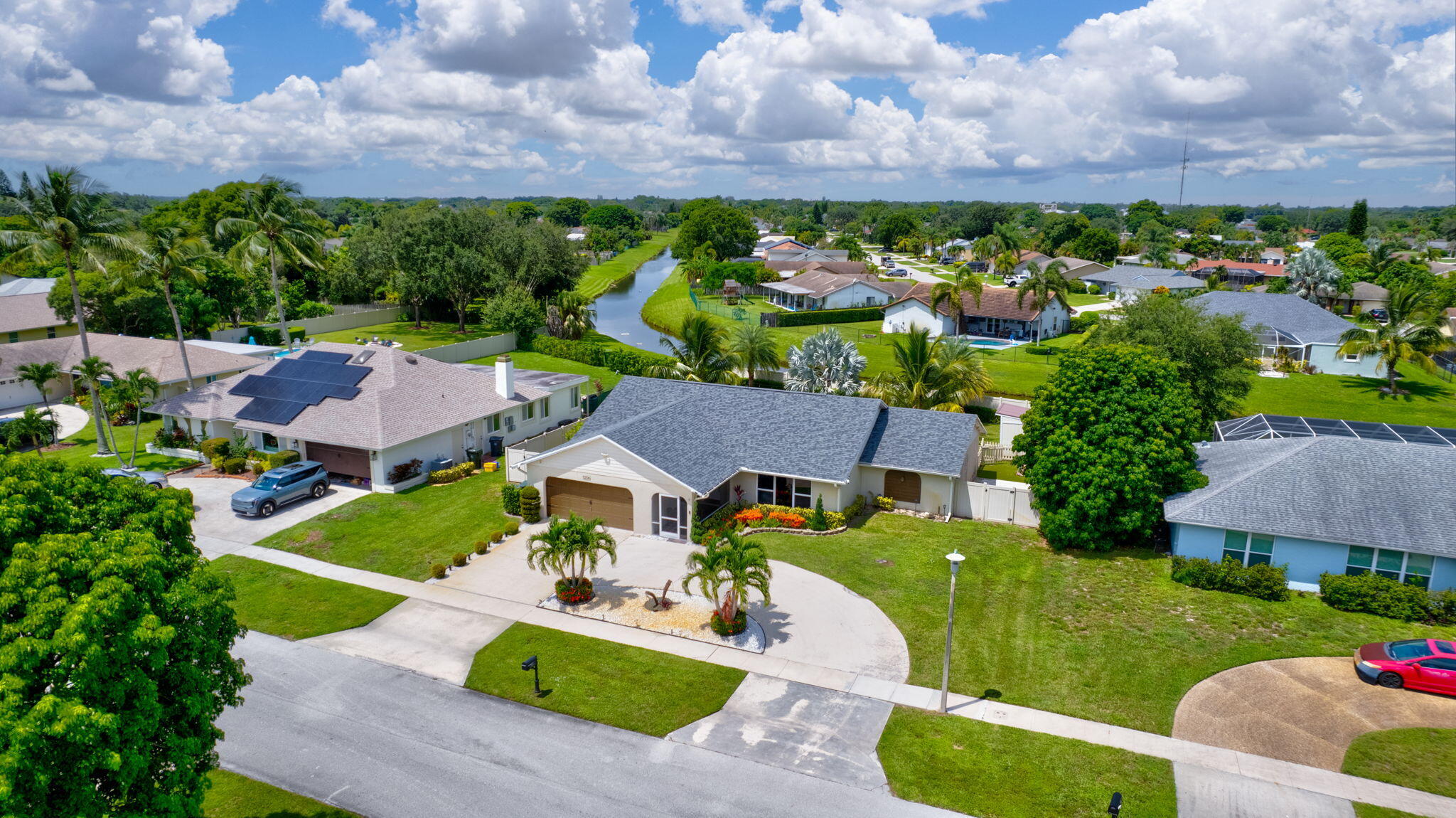1104 Jackpine Street Wellington, FL 33414 - Photo 52 of 67 a view of a house with a yard and a car park