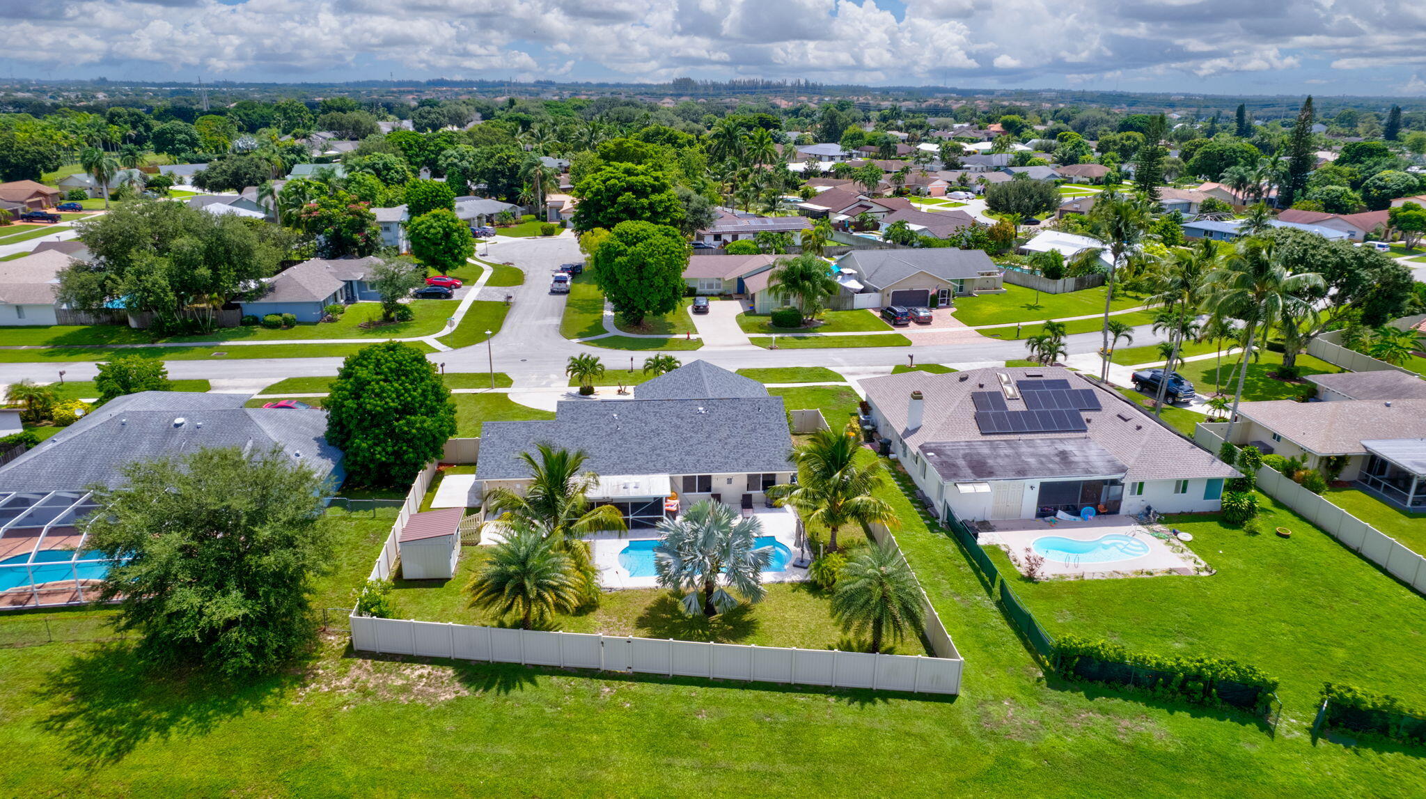 1104 Jackpine Street Wellington, FL 33414 - Photo 60 of 67 an aerial view of residential houses with outdoor space and swimming pool