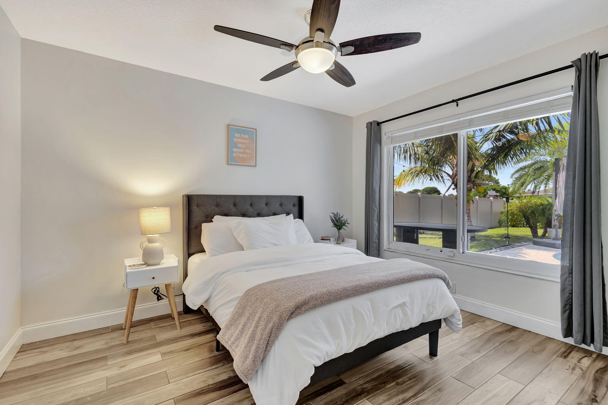 1104 Jackpine Street Wellington, FL 33414 - Photo 6 of 67 a bedroom with a large bed and a large window
