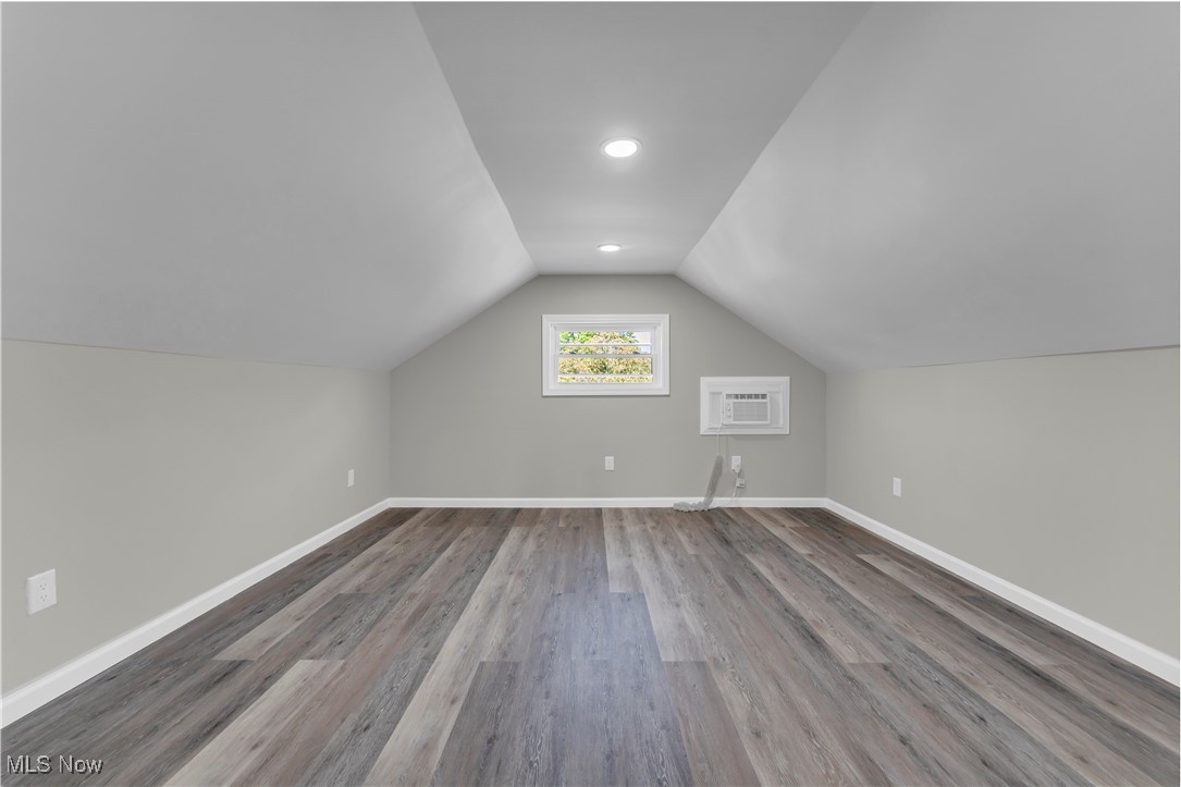 4124 Bayard Road Cleveland, OH 44121 - Photo 24 of 35 Bonus room with lofted ceiling, light wood-style flooring, and a wall mounted AC