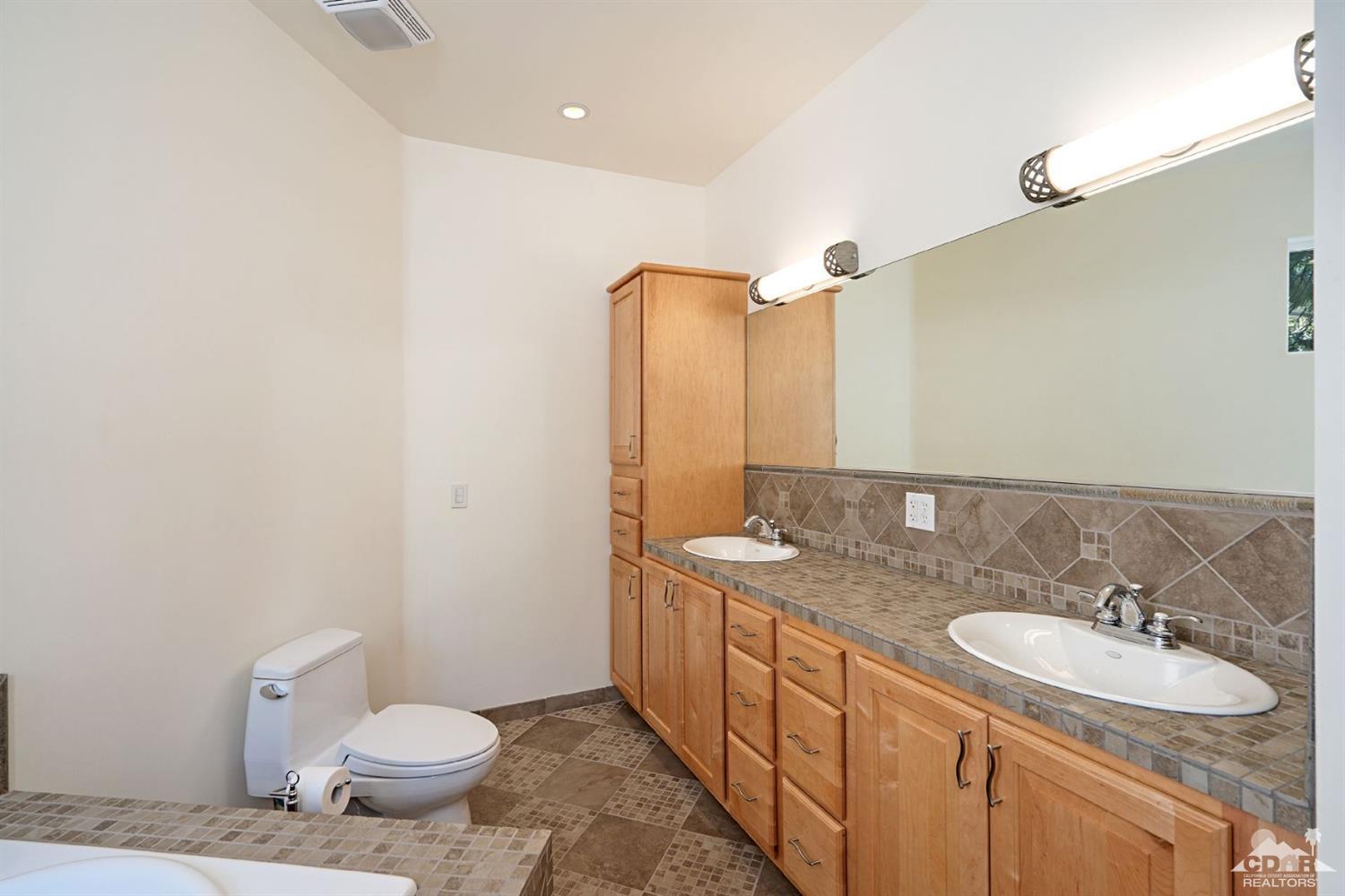 24838 Fern Valley Road Idyllwild, CA 92549 - Photo 13 of 38 a bathroom with a granite countertop sink toilet and mirror