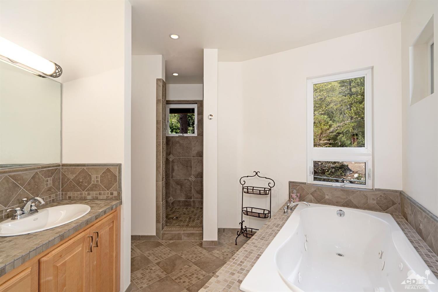 24838 Fern Valley Road Idyllwild, CA 92549 - Photo 14 of 38 a bathroom with a tub sink and mirror